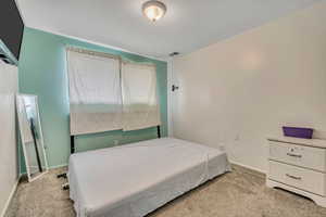 Bedroom with light colored carpet