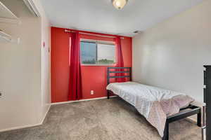 Carpeted bedroom with baseboards