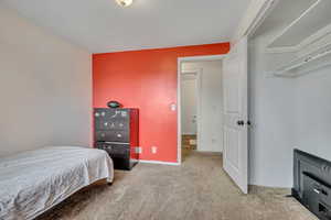 Carpeted bedroom featuring baseboards