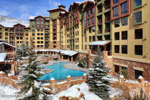 Snow covered pool featuring a community pool and a patio