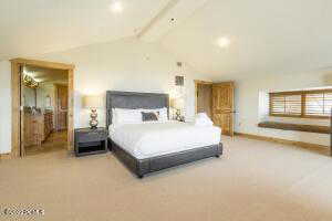Bedroom featuring light colored carpet and baseboards