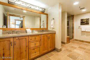 Full bathroom with double vanity and recessed lighting