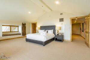 Bedroom with light carpet and recessed lighting