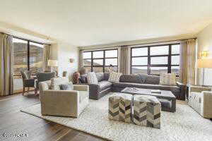Living room with light wood-type flooring and healthy amount of natural light
