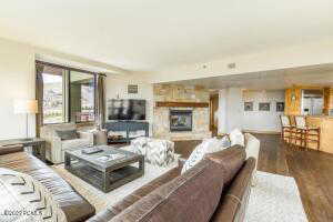Living area with wood finished floors and a fireplace with raised hearth