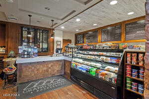 Bar area with wood finished floors, recessed lighting, and hanging light fixtures