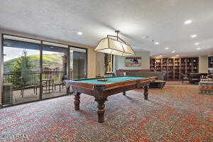 Rec room with billiards, a wall of windows, carpet floors, and recessed lighting