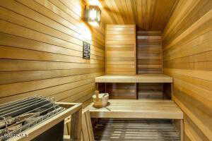 Relaxing sauna / steam room featuring wood ceiling and wooden walls