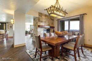 Dining room featuring a fireplace and dark wood-style floors