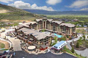 Drone / aerial view of apartment complex and a mountainous background