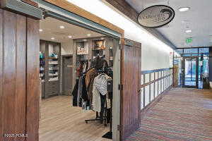 Hallway with light wood finished floors and recessed lighting