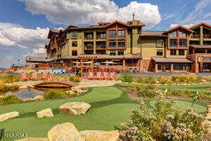 View of community featuring golf course view and a putting green