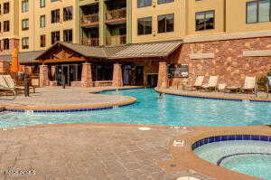 Community pool with a patio and a community hot tub