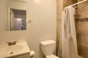 Full bathroom with vanity and tiled shower