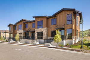 Contemporary home featuring stone siding