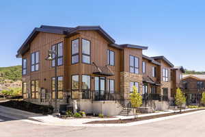 View of front facade featuring stone siding and board and batten siding