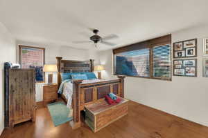 Casita Bedroom featuring multiple windows, wood finished floors, and ceiling fan