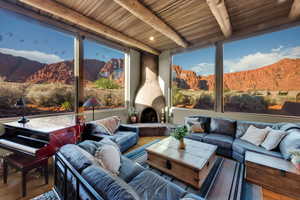 Living area featuring a mountain view, wood finished floors, and a wooden ceiling with exposed beams