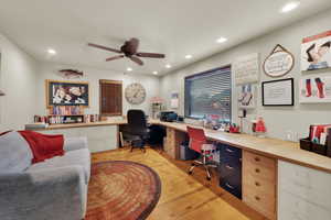 Office area with recessed lighting, built in study area, ceiling fan, and light wood-style floors