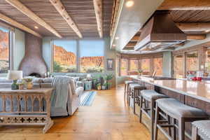 Living room featuring a wooden ceiling with exposed beams, light wood finished floors, healthy amount of natural light, and recessed lighting