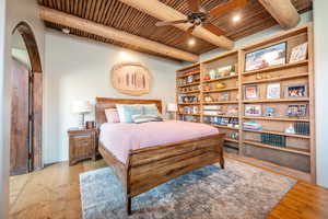 Bedroom featuring a wood ceiling with exposed beams, light wood finished floors, and ceiling fan