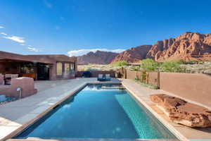View of pool with a patio area, a fenced backyard, and a mountain view