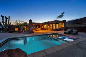 View of swimming pool featuring a patio area and a pool with connected hot tub