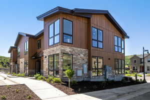 View of home's exterior with stone siding and a central AC unit