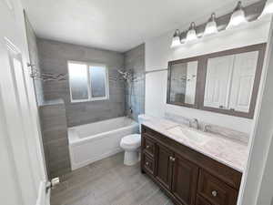 Bathroom featuring washtub / shower combination and vanity