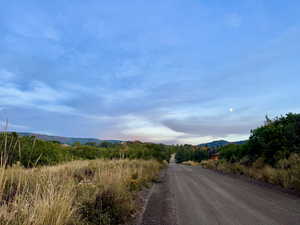 View of dirt / gravel road with a mountain view