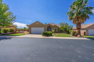 Ranch-style home featuring driveway, stucco siding, and a garage