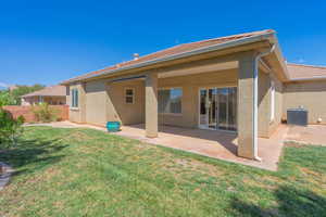 Back of house featuring a patio area, stucco siding, and a tile roof