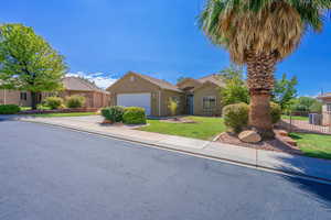 View of front of property with driveway, stucco siding, and a garage