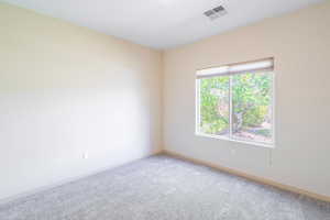 Empty room with carpet and baseboards