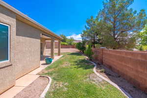 Fenced backyard with a patio area