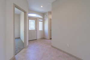 Foyer with baseboards and light tile patterned flooring