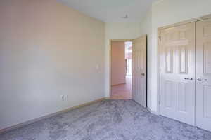 Unfurnished bedroom with carpet floors and a closet