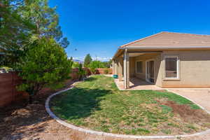 Fenced backyard with a patio