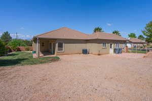 Rear view of property with a patio area and a tiled roof