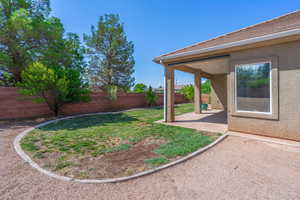 Fenced backyard with a patio area