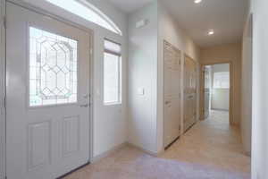 Foyer entrance featuring plenty of natural light, light tile patterned floors, and recessed lighting