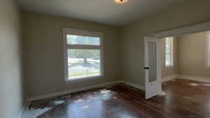 Unfurnished room featuring healthy amount of natural light and hardwood / wood-style flooring