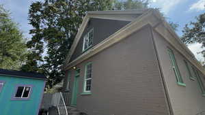 View of property exterior featuring brick siding