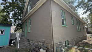 View of property exterior with brick siding