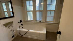 Bathroom featuring dark tile patterned floors and baseboards