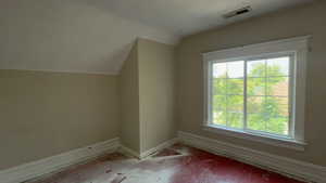 Additional living space with a textured ceiling, hardwood / wood-style floors, and vaulted ceiling