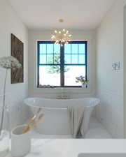 Full bathroom with a soaking tub, tile walls, a chandelier, and a wainscoted wall