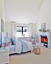 Bedroom with a lit fireplace, carpet floors, lofted ceiling, and recessed lighting