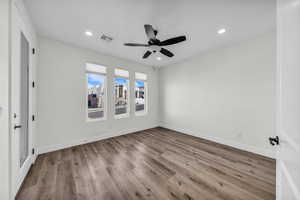 Spare room with light wood-style floors, recessed lighting, and a ceiling fan