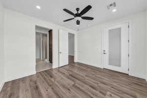 Unfurnished bedroom with light wood finished floors, a ceiling fan, and recessed lighting